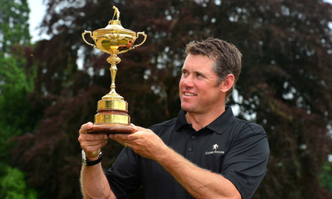 Lee Westwood shows off the Ryder Cup as he opens the course in Northumberland.