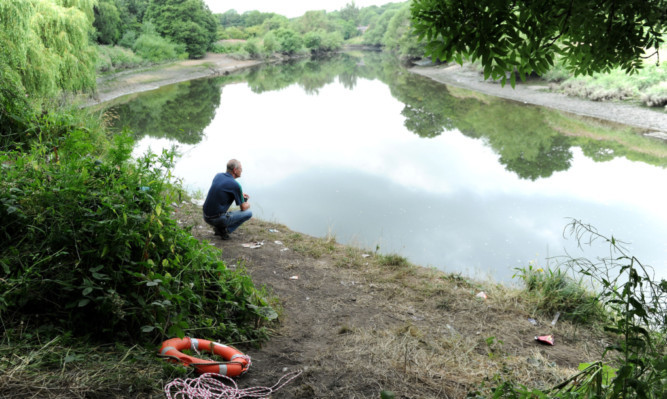 A man looks out across the river where the teenagers died.