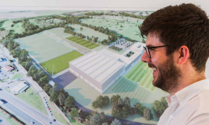 Neil Whatley, architect with Keppie Design Ltd, admires a plan of the proposed centre in Dundee.