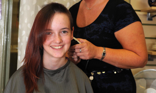 Tia Serman in the hairdresser's chair.