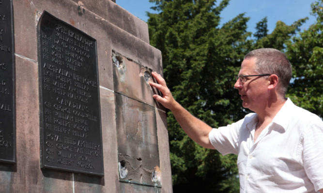 Graeme Stewart at the Milnathort war memorial where plaques have been removed.