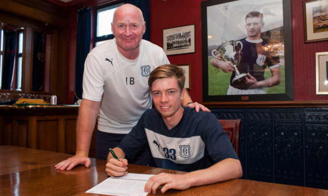 Dundee boss John Brown with teenage striking sensation Craig Wighton as he puts pen to paper on a senior contract.