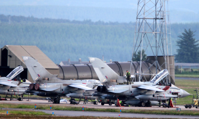 Ground crew work on a Tornado at RAF Lossiemouth.