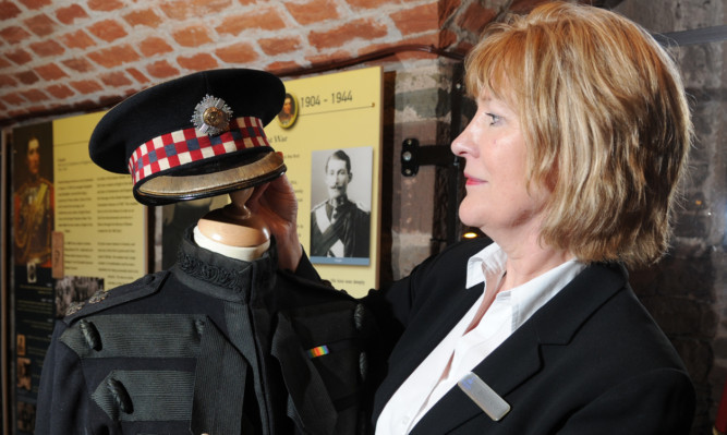 Glamis Castle group sales manager Doreen Stout with the Scots Guards uniform worn by the 15th Earl of Strathmore.