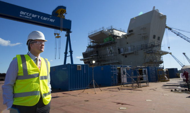 Scottish Secretary Michael Moore during a visit to the partially-complete HMS Queen Elizabeth aircraft carrier in Rosyth Dockyard.