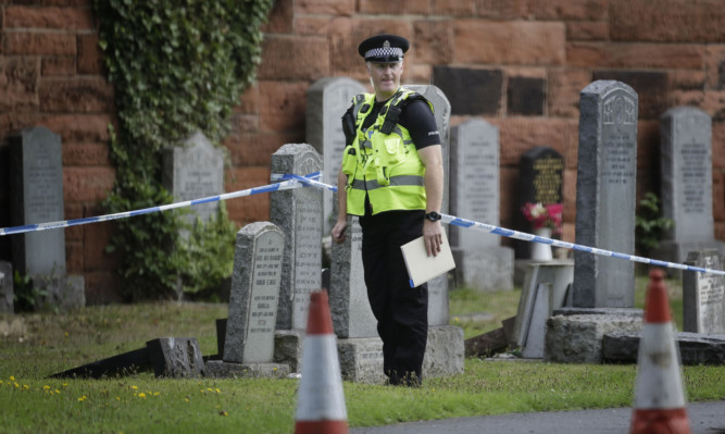 A police officer at the scene after the remains of the baby were found on a path near Seafield Cemetery in Edinburgh.