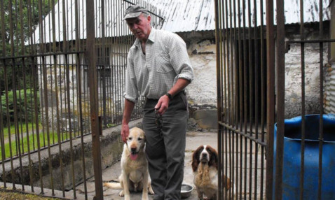 Raymond Baynes, holding the chain cut by the thieves, with his two remaining dogs, Flint and Sunny.