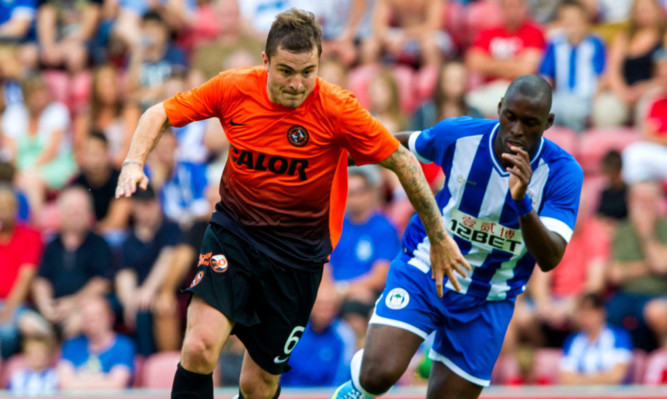 Paul Paton in action against Wigans Marc-Antoine Fortune.