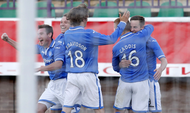 Steven MacLean (right) is mobbed by his St Johnstone team-mates after giving them a crucial away goal.
