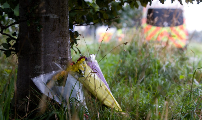 Flowers placed near the site by Tricia Bremner for her deceased son Adam Alexander.