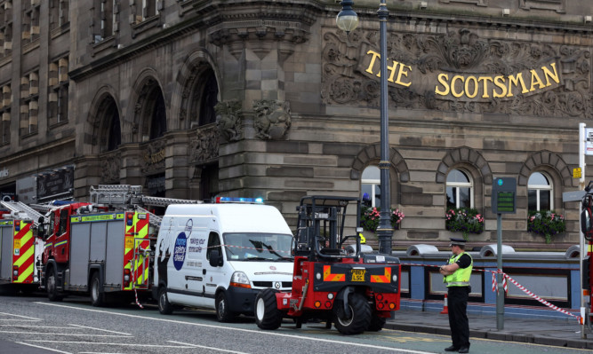 Emergency services arrive at the Scotsman hotel Edinburgh after two bodies were found in one of the bedrooms.PRESS ASSOCIATION Photo:Photo date:Thursday 01 August,2013.See PA story.Photo credit should read David Cheskin/PA wire.