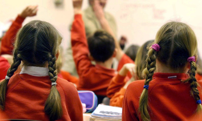 File photo dated 03/12/03 of pupils during a lesson as under-performing schools could be forced to expand to deal with a chronic shortage of places for children, MPs have warned.