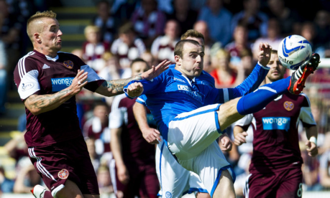 St Johnstone's Dave Mackay (right) clears under pressure from Ryan Stevenson.