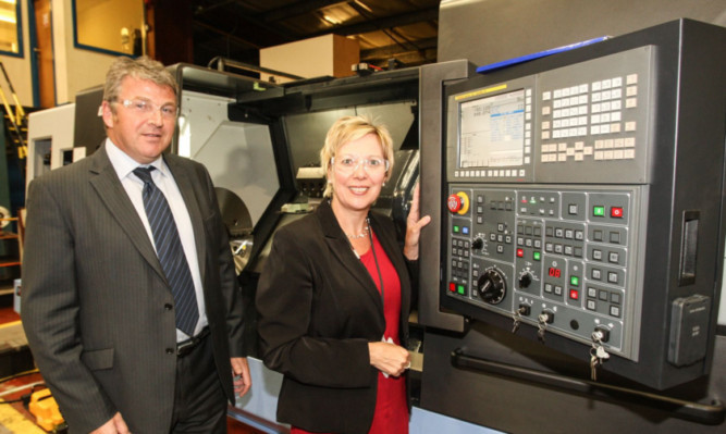 Duncan McDougall and Lesley Laird with the first of the new CNC lathes.