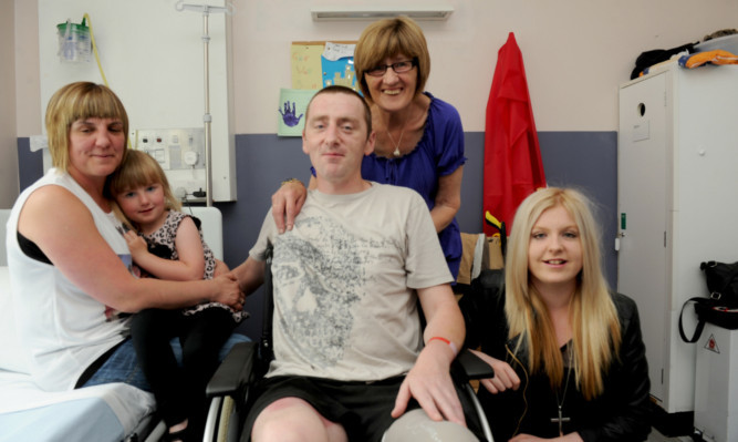 Greig Yorke from Carnoustie in Ninewells Hospital with wife Allie, daughters Lily and Jamie, and mum Jane Burgess. Inset: Carnoustie Boys Brigade Hall.