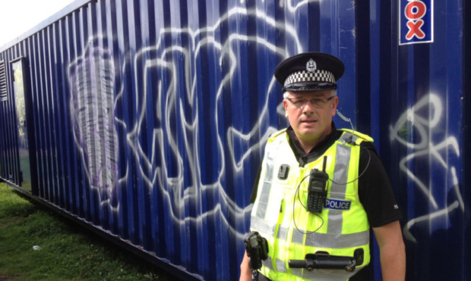 PC Dave Gallacher at the site of the Robertson Street graffiti.