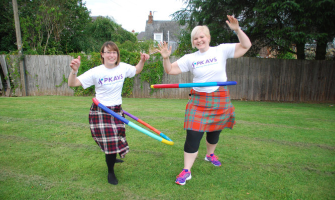 PKAVS supporters Lisa Barron, left, and Jaclyn Dallas hold a kilted hula hoop practice session.