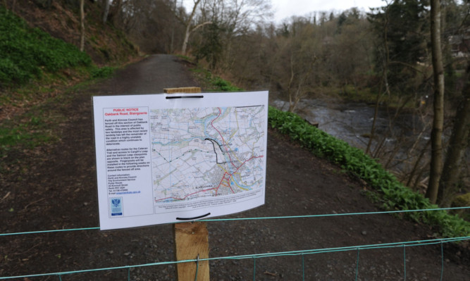 The sign warning walkers that the popular pathway has been closed after a landslip.