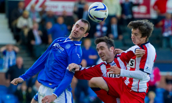 St Johnstone's Dave Mackay does well to clear under pressure from Paul Heffernan (centre) and Chris Johnston (right).