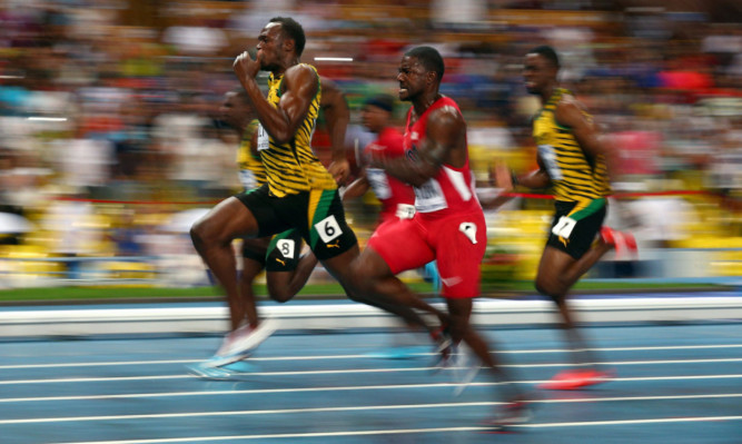 Golden moment: Usain Bolt leads Justin Gatlin in the mens 100 metres final in Moscow.