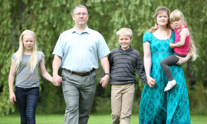 Angus and Kate McLaughlin, with their three children Cian, centre, Aine, and Aoife.