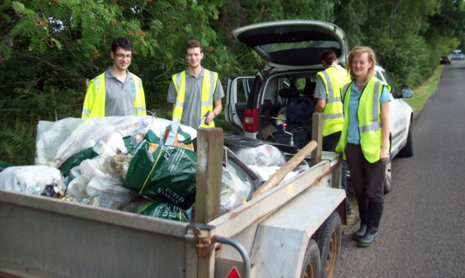 Volunteers from the Scottish Wildlife Trust with rubbish collected from Craiglush Loch, which is next to Loch of the Lowes, near Dunkeld.