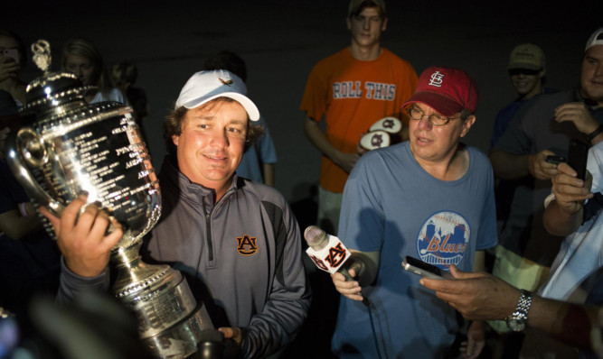 Jason Dufner shows the Wanamaker Trophy to reporters after arriving in Auburn, Alabama.