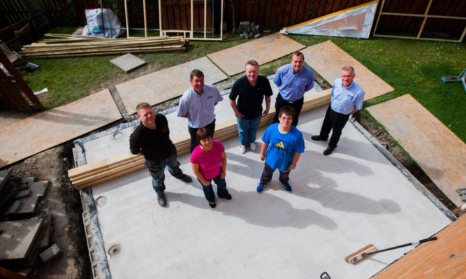 Working on the new extension are, back from left: Mike Telfer, of Telfer Joinery, Alex Prattis, Mark Bennett, Casey Prattis and George Beattie, all of AB Prattis. Front: Debbie Watson and her son Calum.