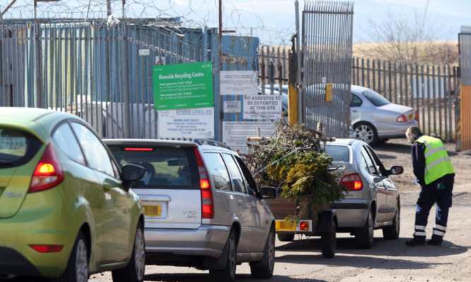 Cars queue with garden waste at the Riverside recycling site.
