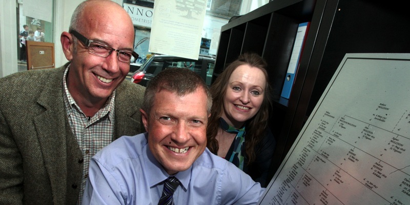 John Stevenson, Courier, 09/08/11. Fife. Dunfermline, Willie Rennie traces family tree at the Genealogy Clinic. Pic shows Willie(centre)  with Genealogy Clinic partners Lloyd Pitcairn and DebbieMcLean as he points out his place in the line.
