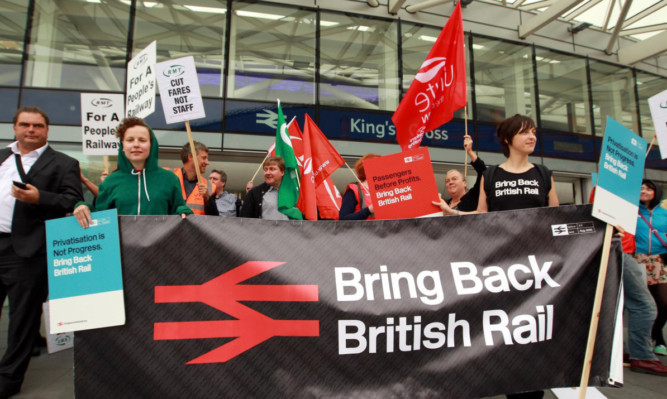 The Action for Rail campaign group protest over rail fares outside Kings Cross Station in London.