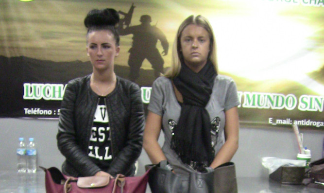 Scottish teenager Melissa Reid, right, and Michaella McCollum Connolly stand behind their luggage after being detained at the airport.