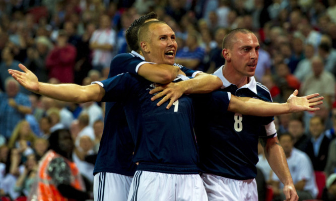 Kenny Miller celebrates his superb goal for Scotland.