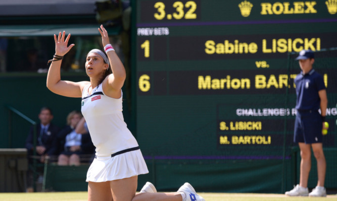 Marion Bartoli sinks to the ground after winning Wimbledon.