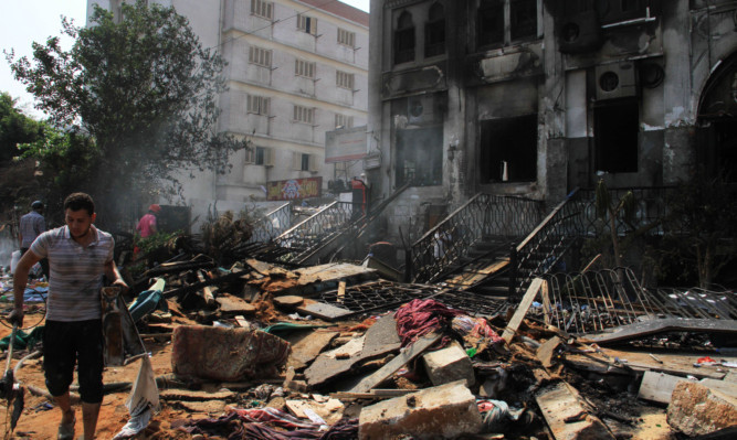 A man sifts through debris at the burnt Rabaah al-Adawiya mosque in Cairo's Nasr City.