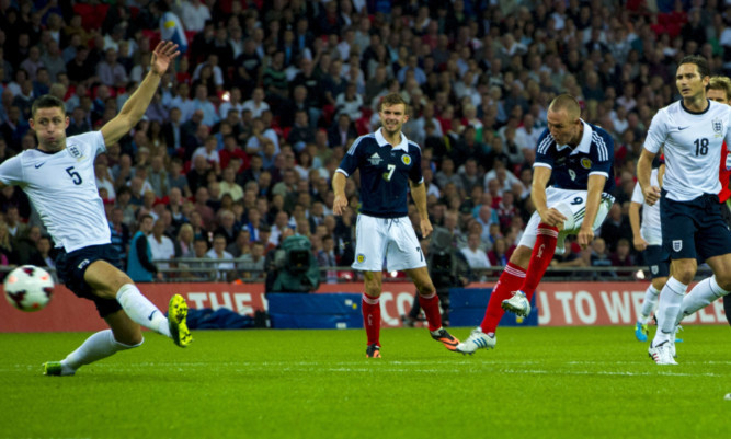 Kenny Miller scores against England during the 3-2 defeat at Wembley.