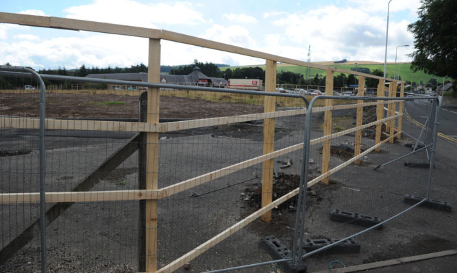 The fence that is being erected around the ground next to Tesco in Cupar.