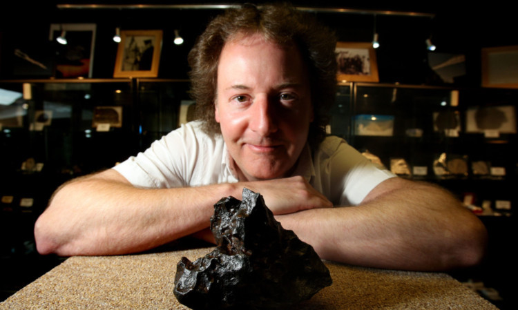 Robert with an iron meteor found in Canyon Diablo in Arizona.