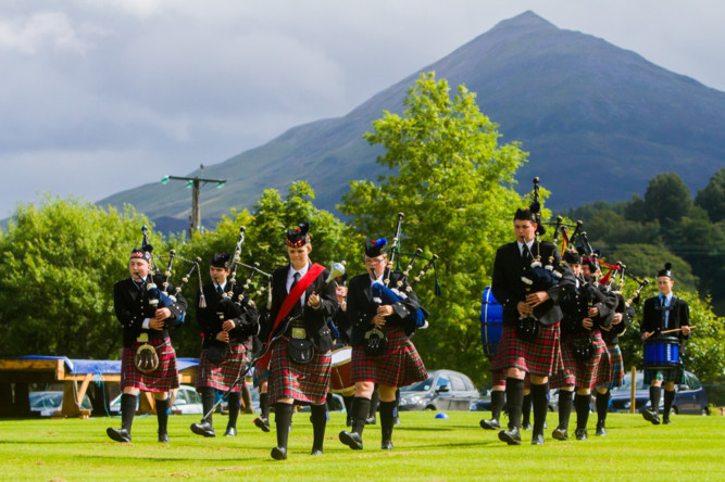 While umbrellas were out in most of Courier Country, the sun shone on Kinloch Rannoch for the annual Highland Gathering. Despite a sluggish start, crowds flocked to Weller Poley Park to enjoy the latest stage in the Scottish Heavyweight Championships, as well as the track and field and hill race events. Photo shows Auchterhouse Pipe Band opening the event.