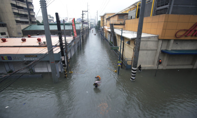 Roads become rivers in the financial district of Makati, south of Manila.