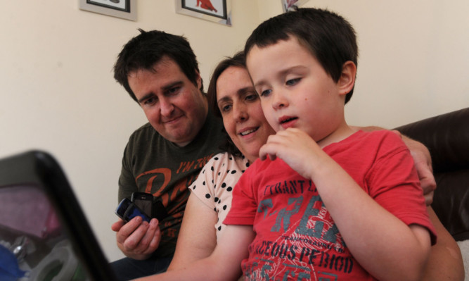 Cameron Mackenzie at home with mum Farrah and dad Graham.