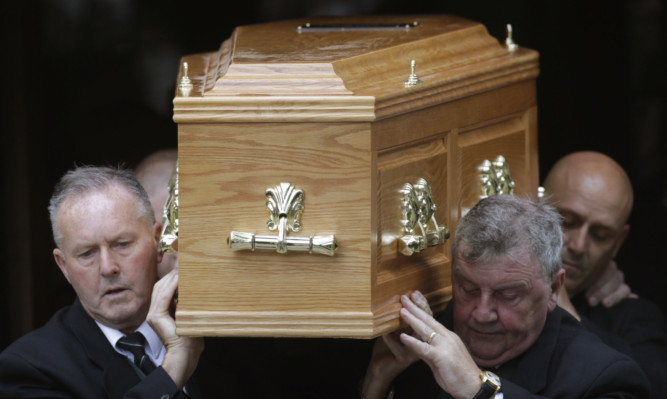 The coffin of former Scottish Tory leader David McLetchie is carried from St Columba's Church.