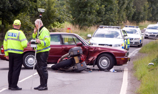 Police attend at the scene of the fatal crash on the A85 on August 22 last year.