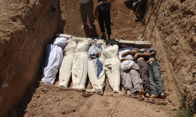 This image provided by Shaam News Network, which has been authenticated based on its contents and other reports, purports to show a mass grave in a suburb of Damascus.