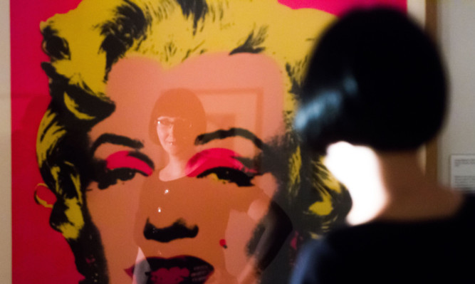 Sarah Saunders reflected in a Marilyn Monroe print by Andy Warhol.