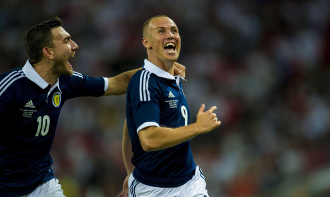 Finishing on a high: Kenny Miller celebrates scoring against England at Wembley.