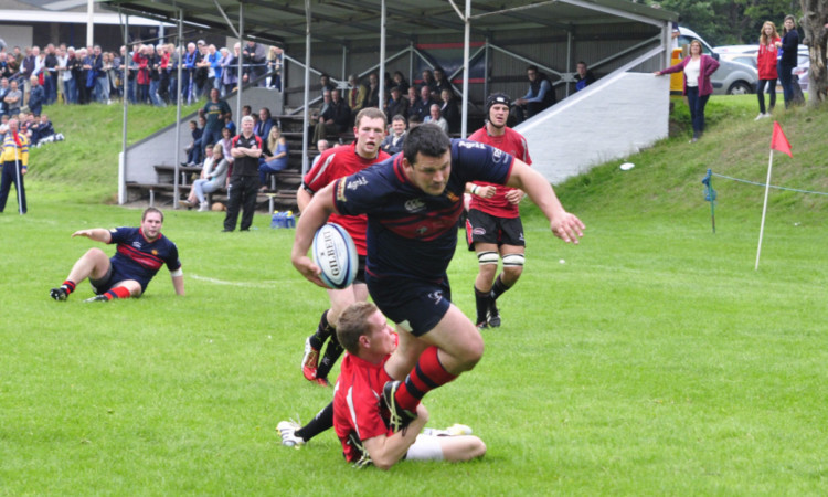Dundee Highs Alan Brown battles for the line and one of his two tries.