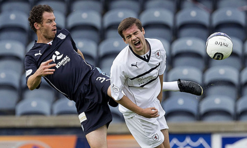 Dundee's Matt Lockwood pokes the ball away from Lewis Vaughan (right).