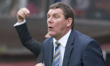 Tommy Wright watching his players fall to a heavy defeat at Tannadice.