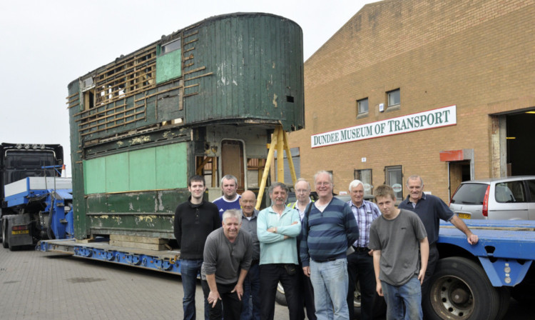 The tram and some of those involved in its recovery.